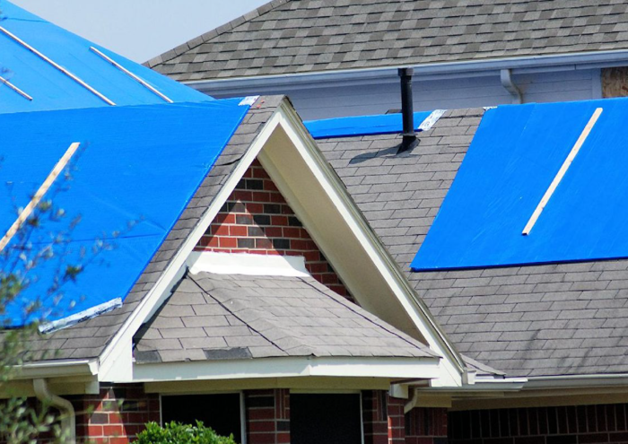 A professional team installing a new roof on a residential home in Houston, Texas with RM Roofing.